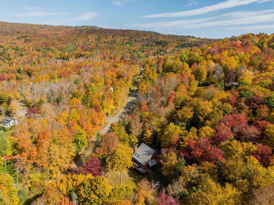 Breathtaking aerial view of vibrant fall colors nearby.