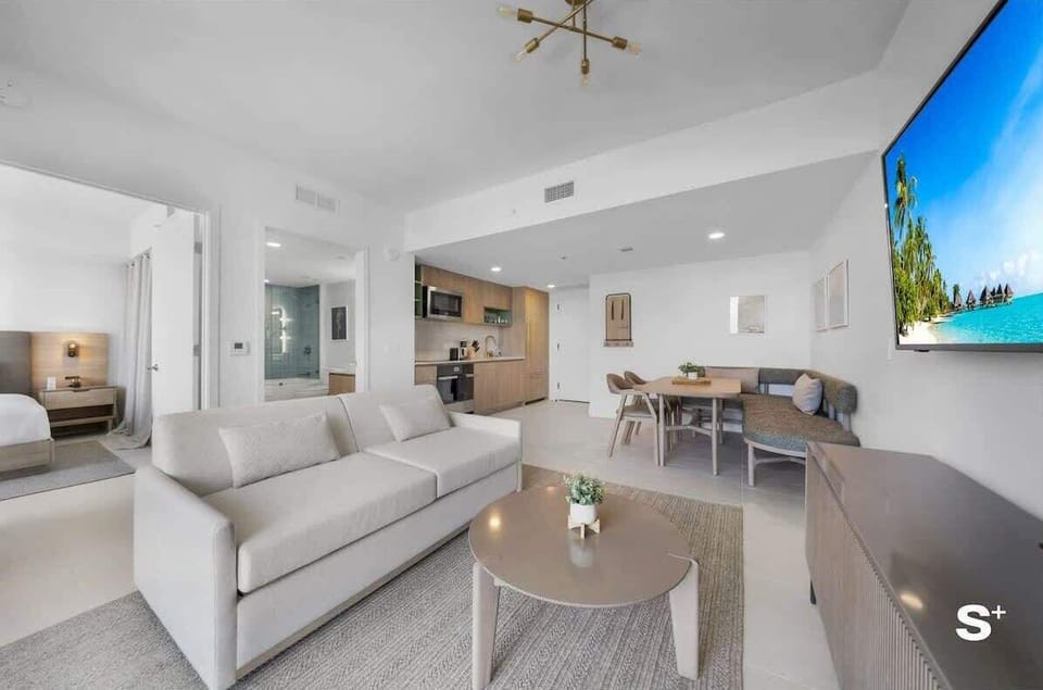 Living room: features a sofa bed TV Dining Area and open kitchen