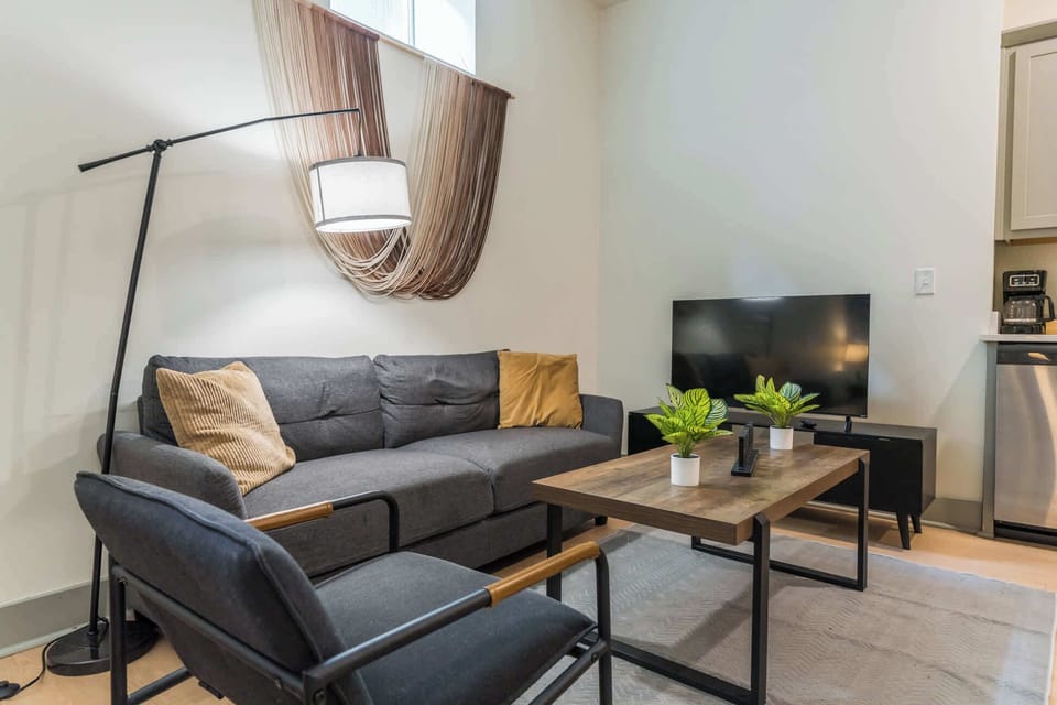 Living Room: A light-filled studio living space that’s cozy, clean, and guest-ready room