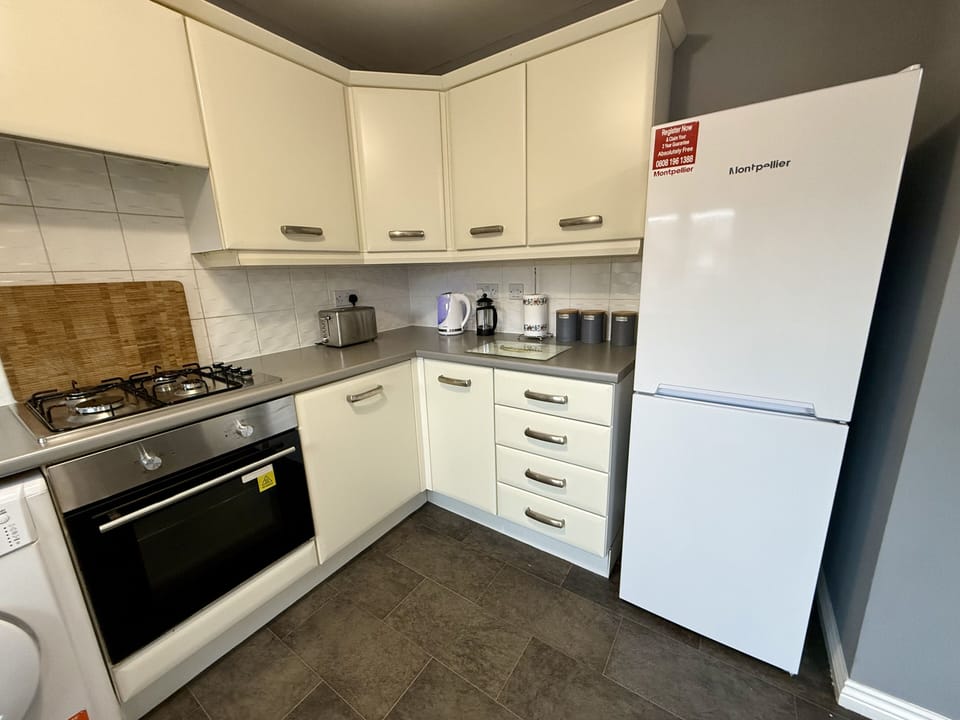 Kitchen with electric hob and oven, fridge freezer & dishwasher