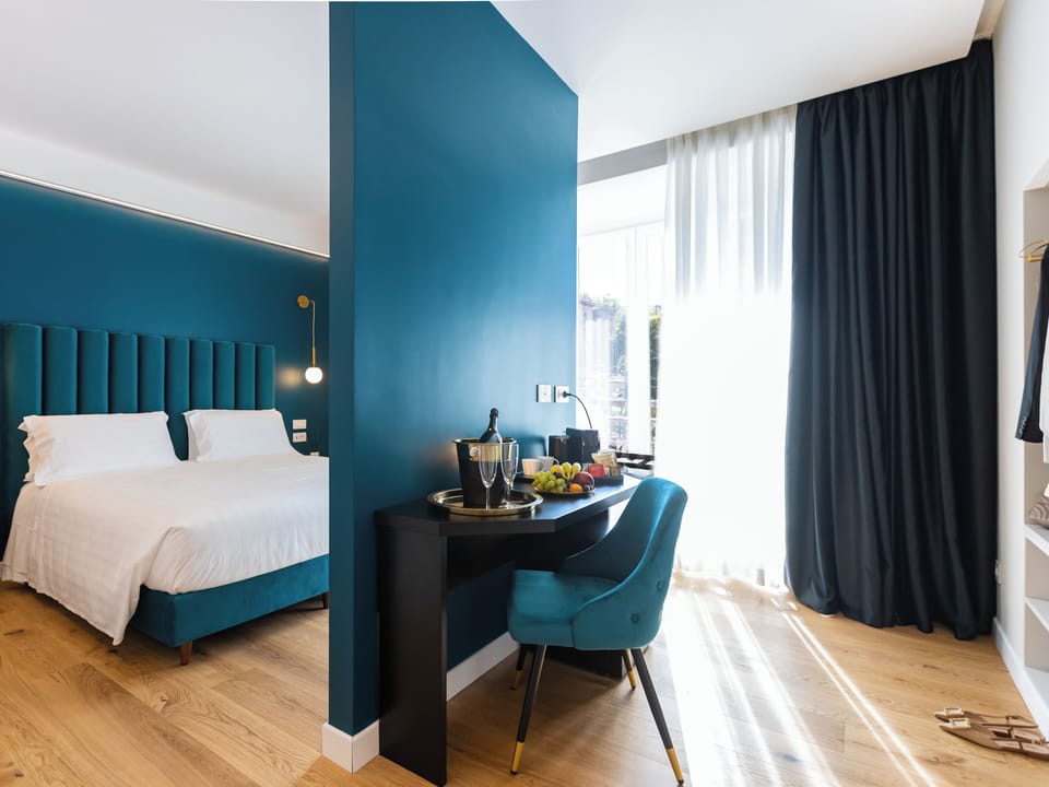 Queen Deluxe , River View | Minibar, in-room safe, desk, laptop workspace