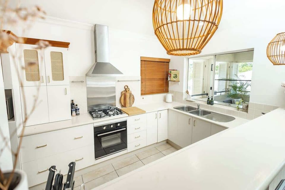 Generous bench space and pendant lighting make the kitchen a comfortable spot to cook in company.