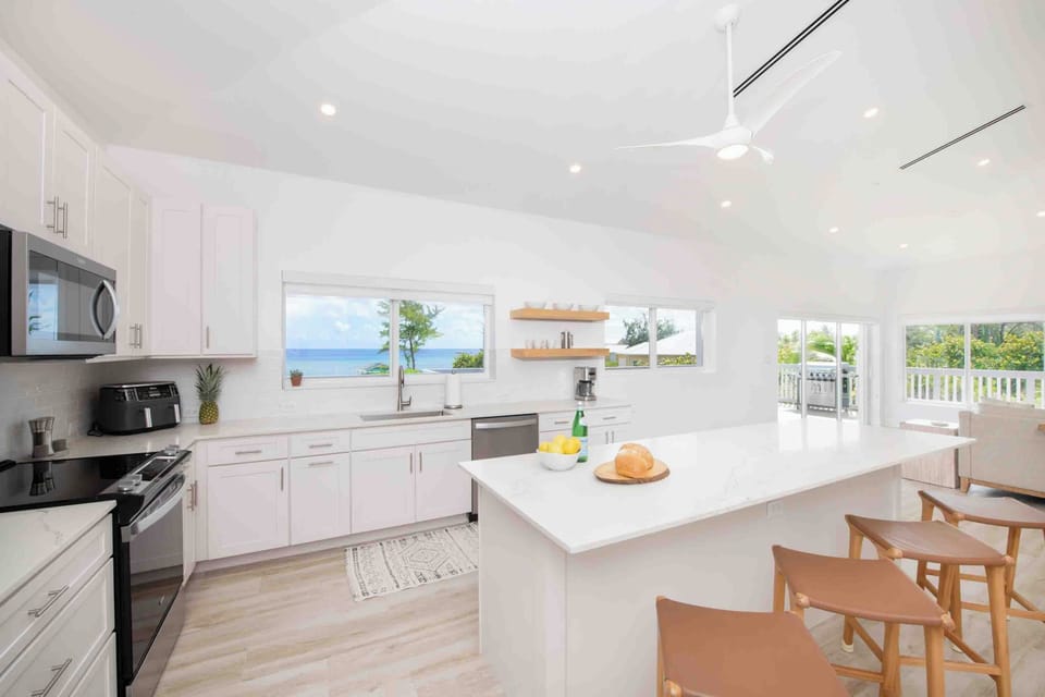 Spacious full kitchen with modern appliances and island seating. 