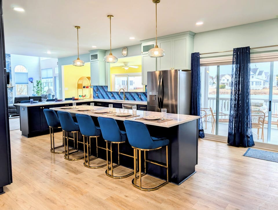 31311 May Drive, Bethany Lakes, Bethany Beach - kitchen - Reverse view of the gourmet kitchen showing the expansive marble-style island and dining flow.