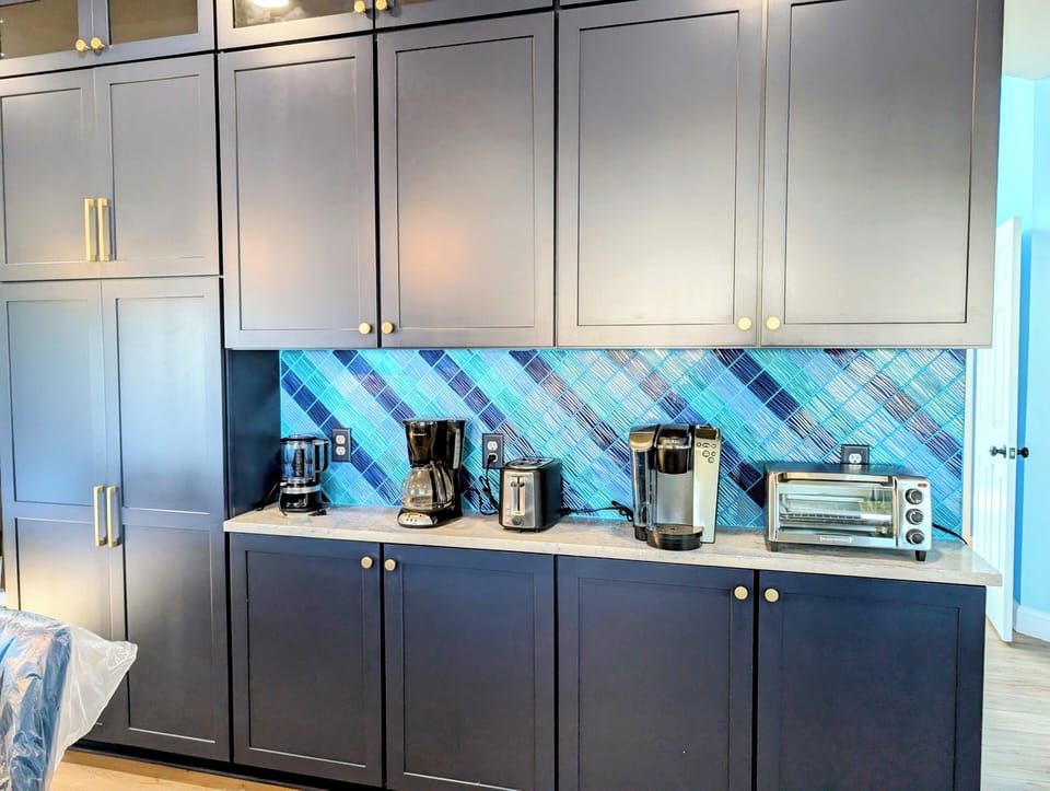 31311 May Drive, Bethany Lakes, Bethany - appliance center - Gourmet kitchen detail highlighting the custom blue tile backsplash and sleek professional cabinetry.