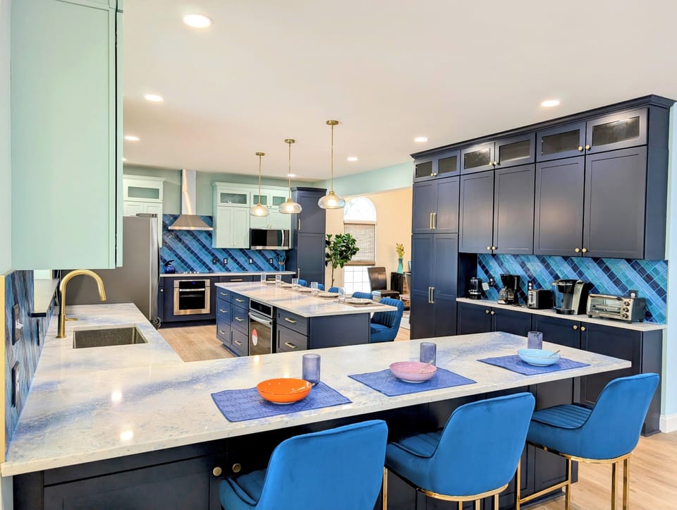 31311 May Drive, Bethany Lakes, Bethany Beach - Kitchen - Designer chef's kitchen with an oversized navy island, quartz countertops, and high-end stainless appliances.