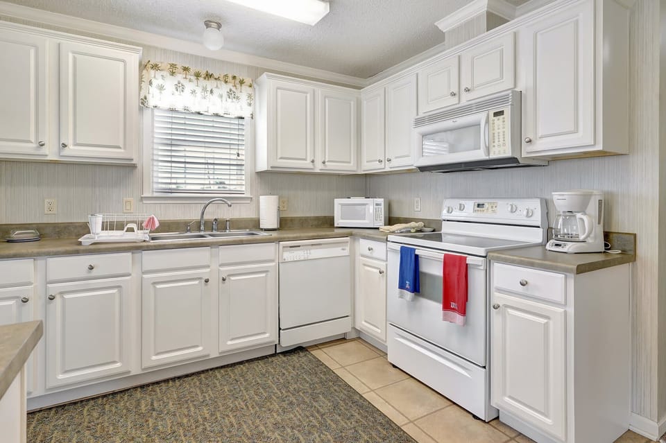 The kitchen includes a full set of appliances 