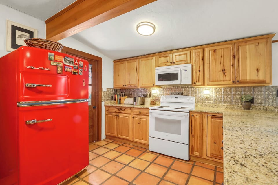 Kitchen features include vintage red refrigerator, and all other appliances needed for cooking at home