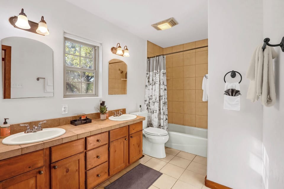 Bathroom one is attached to the primary room and has a shower/tub combo