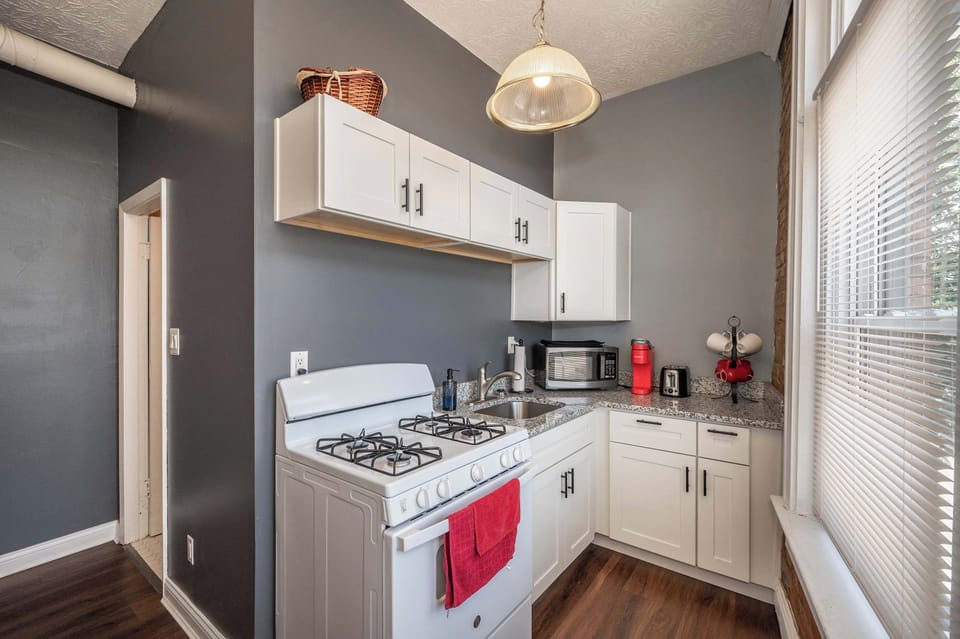 Enjoy the comforts of home & historic exposed brick of the kitchen