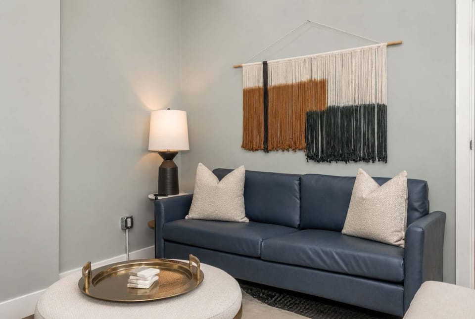 Unwind in this stylish and spacious living area, thoughtfully designed with comfortable seating, warm natural light, and modern décor.