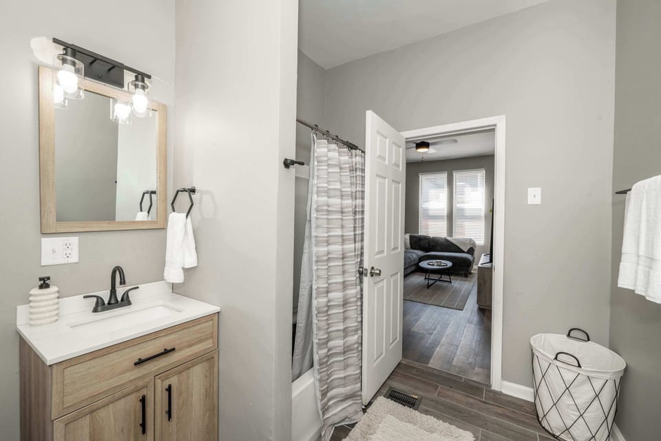 The 1st floor full bathroom offers a single vanity & shower/tub combo