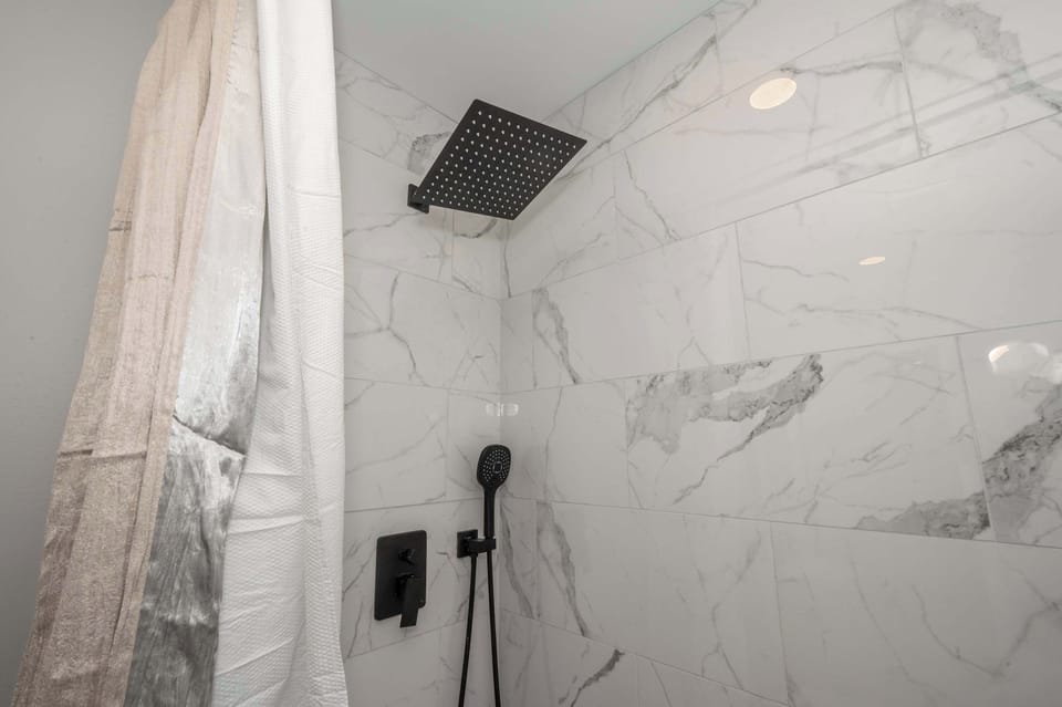 The full bathroom offers guests a single vanity & walk-in shower