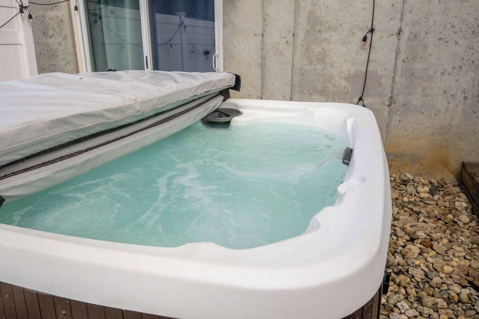 Soak under the stars in a private hot tub oasis ✨🛁 Surrounded by string lights and a cozy privacy fence, it’s the perfect place to unwind and relax!