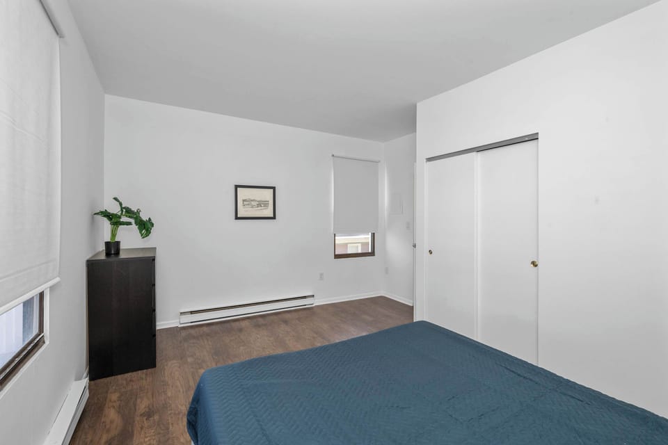The serene bedroom retreat features a plush queen-sized bed