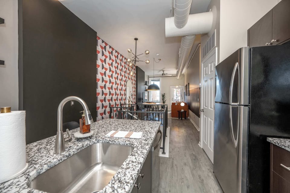 The sleek, open kitchen offers ample space & every home comfort