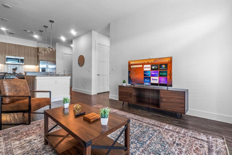 The living room is filled with natural light, creating a bright and welcoming space that invites relaxation.