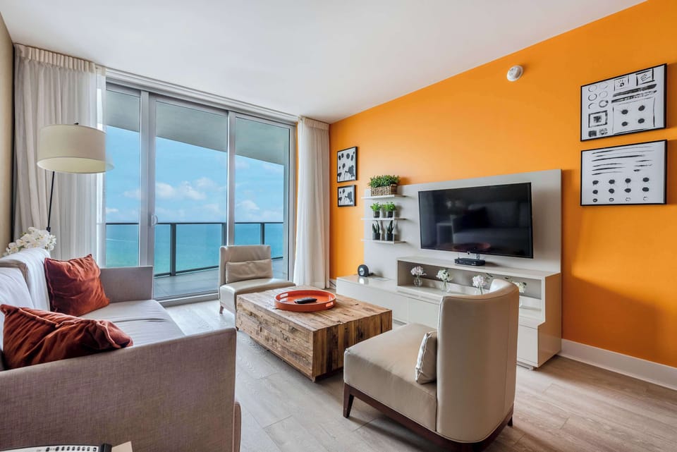 The living room offers a sofa that coverts to a sleep, TV, and balcony access