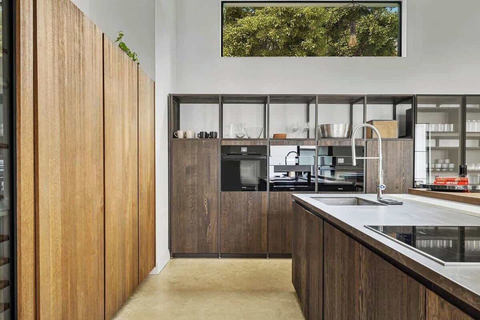 Your gourmet kitchen features sleek wood cabinetry and modern appliances, perfect for preparing memorable meals during your stay.