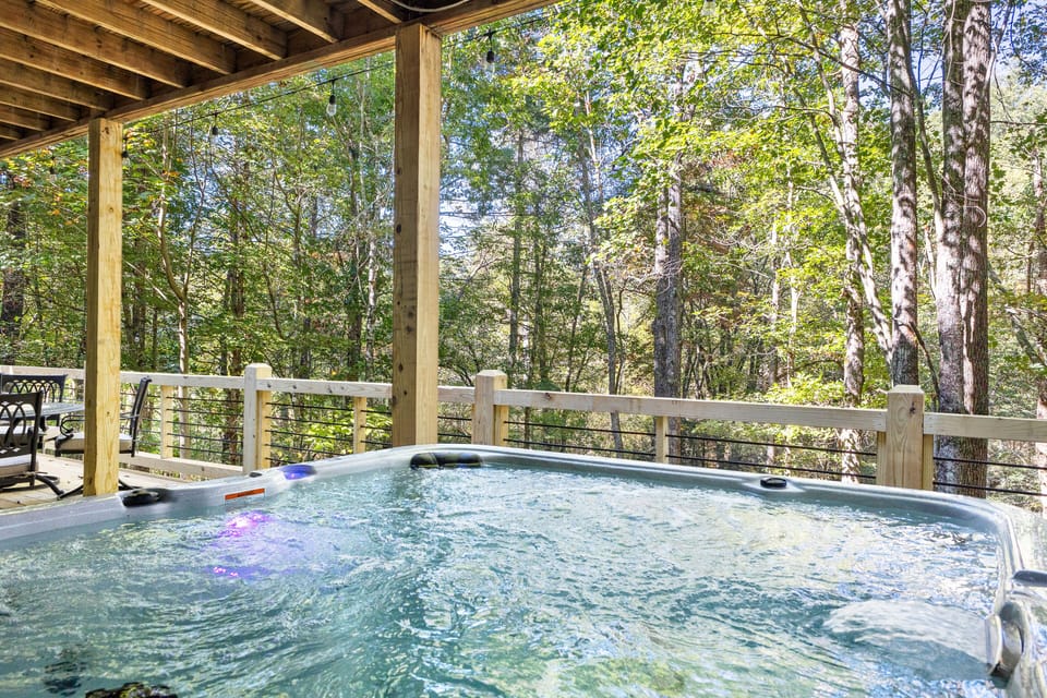 Relax and warm up in the hot tub overlooking the trees and creek.