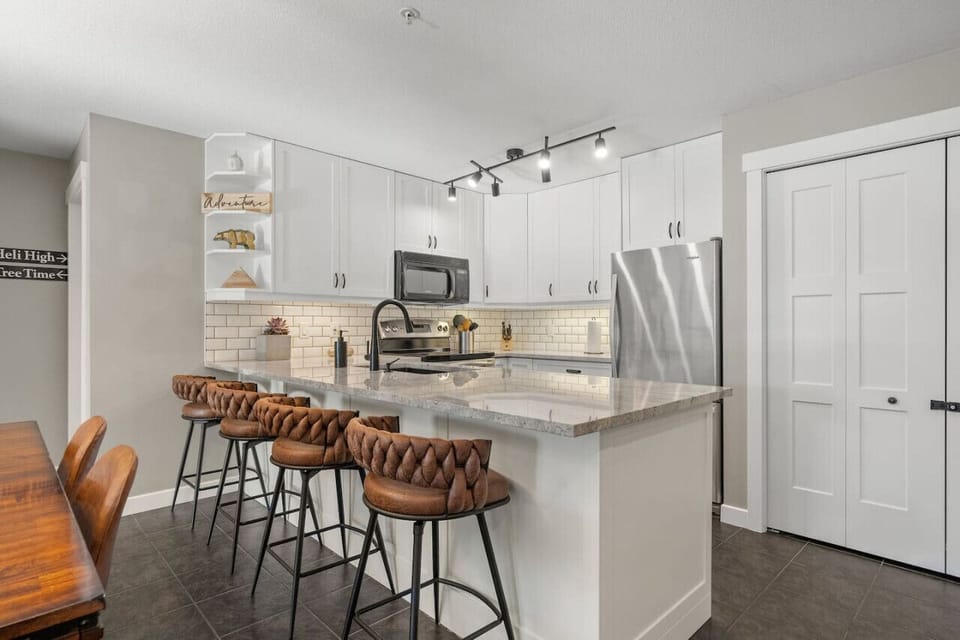 Full kitchen with a blender, crockpot, panini press, hand mixer, popcorn maker, drip coffee machine, ground coffee, tea, sugar, and basic condiments (ketchup, mustard, relish.)