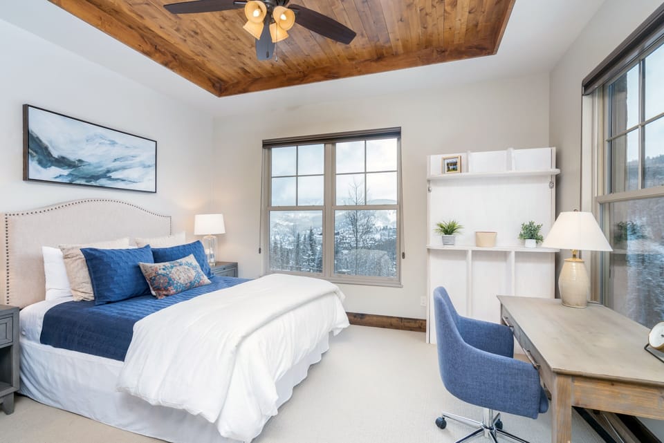 The guest bedroom features unobstructed mountain views and comfortable bedding for up to 3 guests
