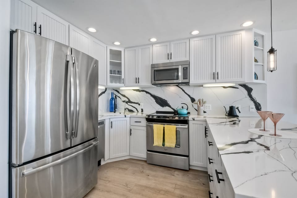 The chic, open kitchen offers ample space & all the comforts of home