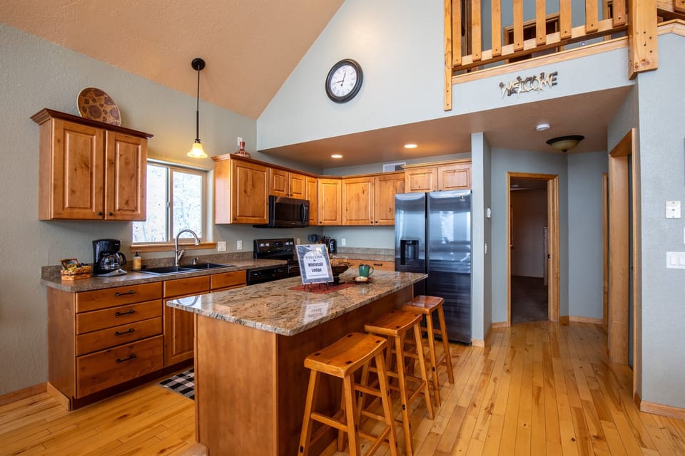  A spacious granite kitchen island makes meal prep easy, offering plenty of room to spread out, durable surfaces for chopping, and an easy-to-clean finish.