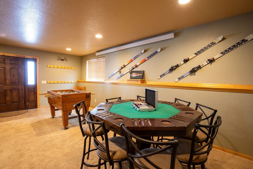 The lower level living room is perfect for a lively game of foosball or enjoying a few hands of cards at the poker table, making it an entertaining spot for everyone to gather.