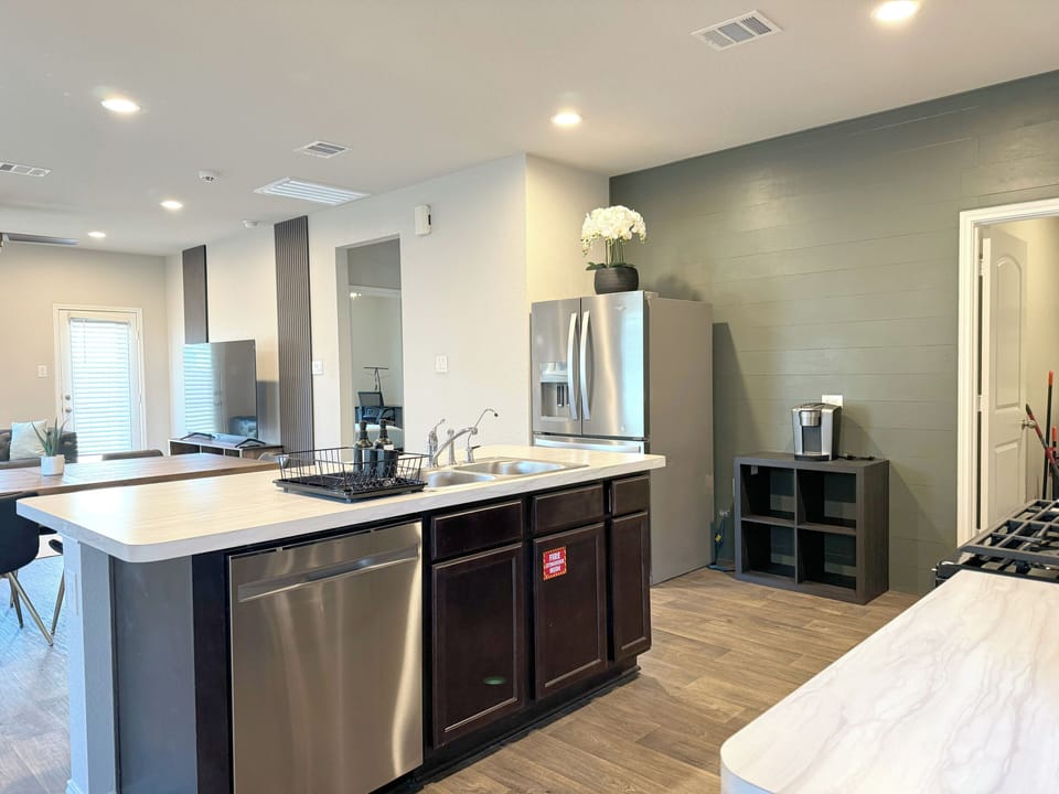 Fully stocked kitchen with large fridge, water filters and keurig coffee maker