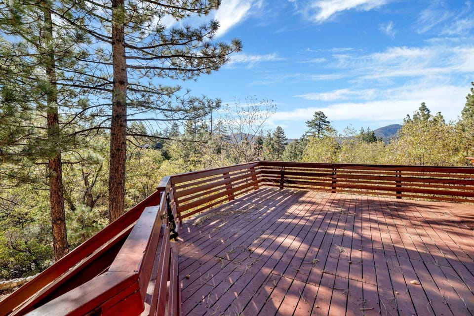 Private outdoor deck, surrounded by tall pines, perfect for relaxing under the trees after a day of adventure—enjoy peaceful forest views, fresh air, and a truly rejuvenating stay.