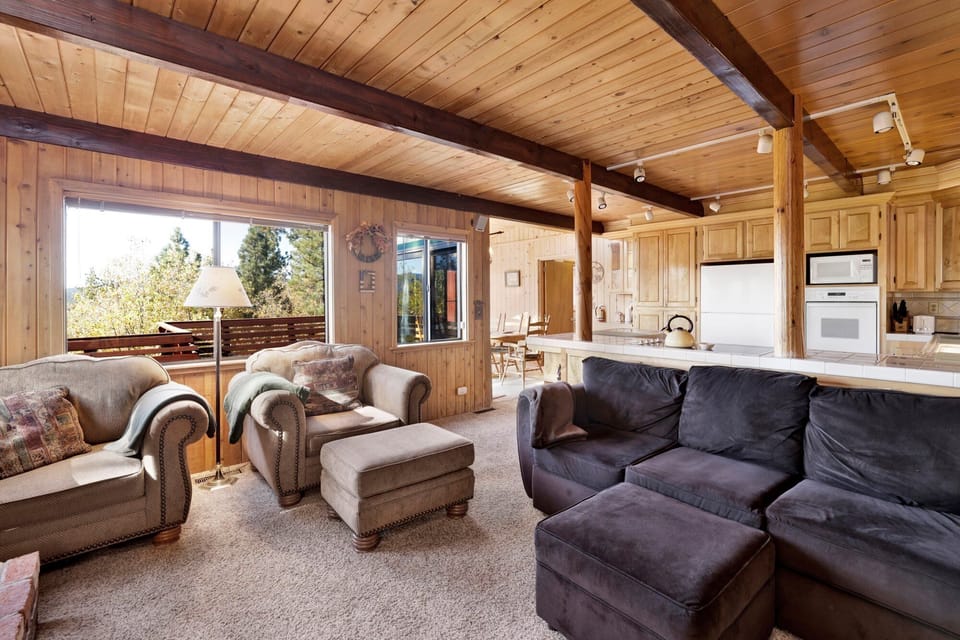 Cozy mountain living room with comfy seating, and smart TV—perfect for relaxing evenings, movie nights, and warm cabin vibes after outdoor adventures.