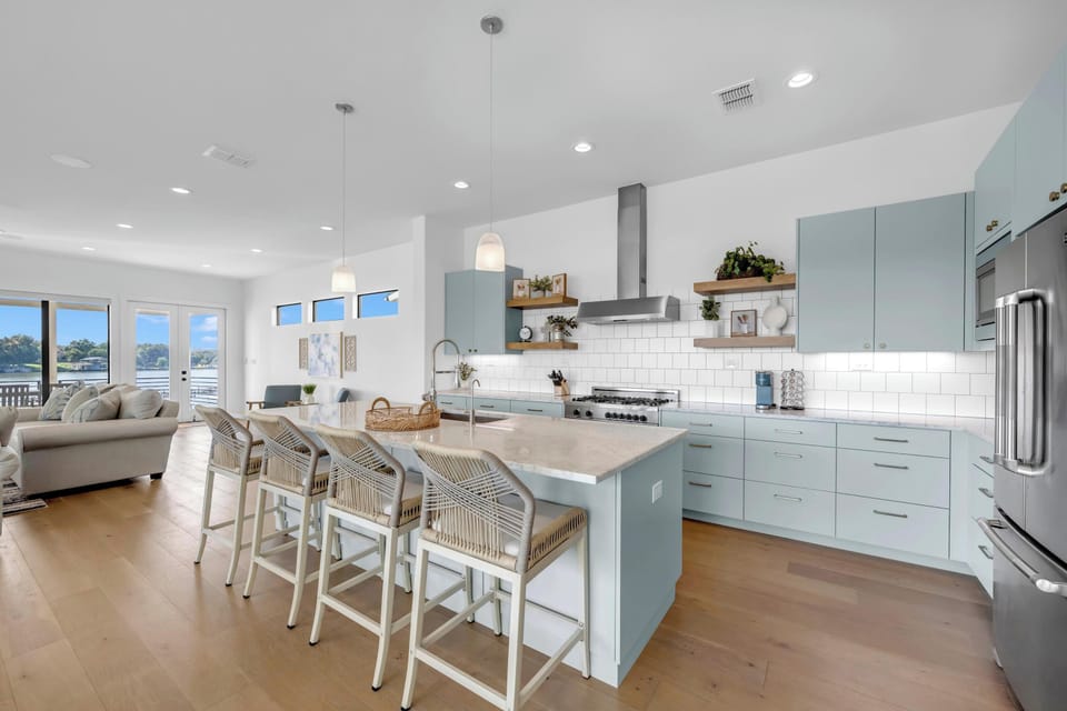 The kitchen is stocked with upscale appliances and cookware essentials