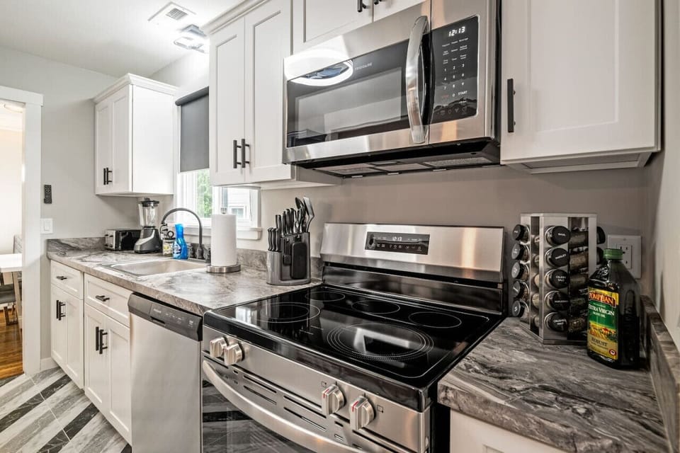 Whip up culinary delights in this fully-equipped, sleek kitchen. With a dishwasher, large fridge, stove, microwave, and plenty of counter space, meal prep is a breeze.