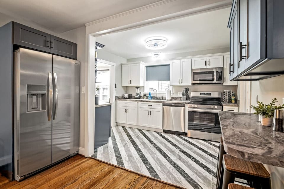 Whip up culinary delights in this fully-equipped, sleek kitchen. With a dishwasher, large fridge, stove, microwave, and plenty of counter space, meal prep is a breeze. Pull up a seat at the bar for a quick snack or sip coffee.