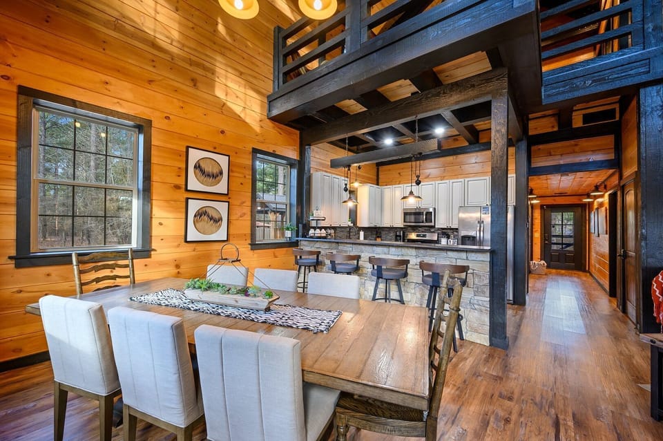 Dine at the table for 8 supplemented by barstool seating for 4 at the bi-level kitchen peninsula and additional seating at two living-room tables.