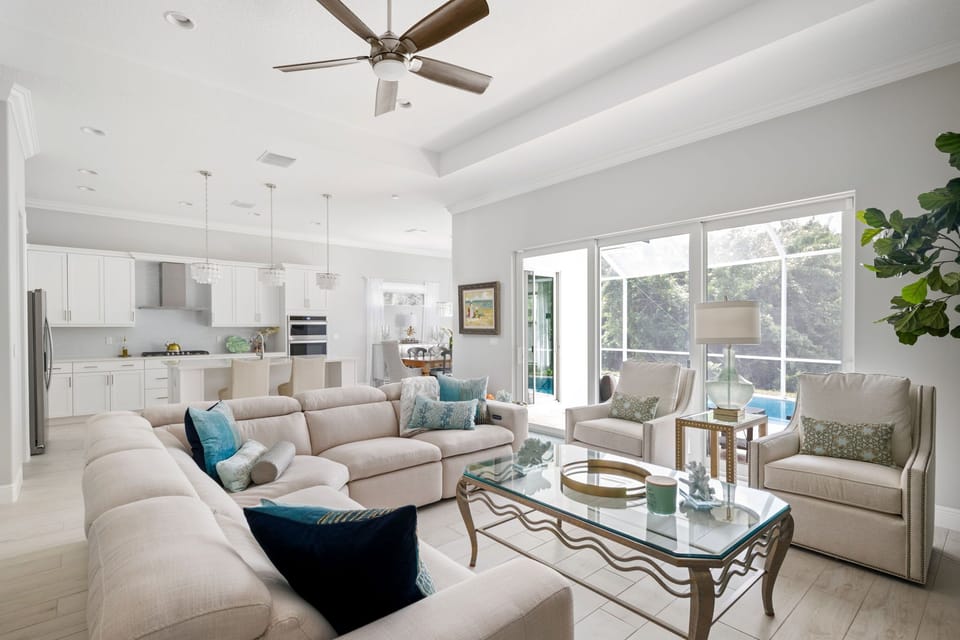 The living room is the perfect spot to unwind after a long day. Admire the view of the pool while watching TV or lounging on the reclining  couch.     
