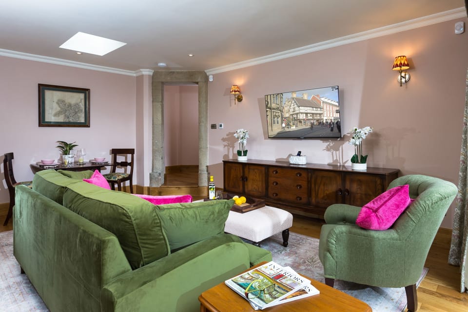 Comfortable soft velvet sofa and large Smart television in the sitting room