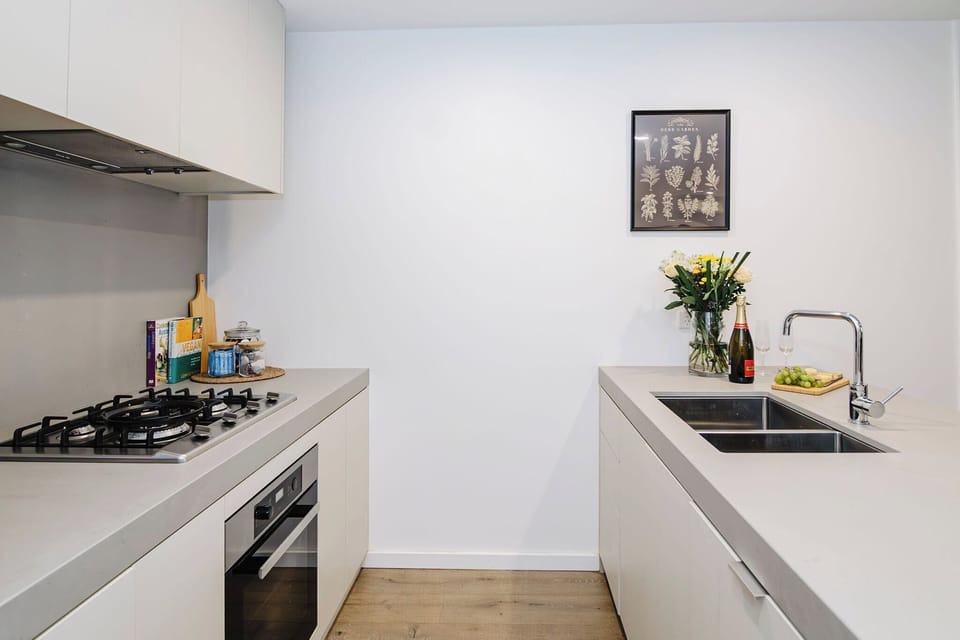 Experience effortless elegance at this sleek kitchen counter, featuring a modern sink that combines style with functionality for all your culinary adventures
