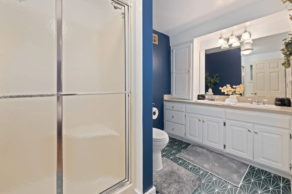 The en suite bathroom in the basement room with bathtub and shower attachment.