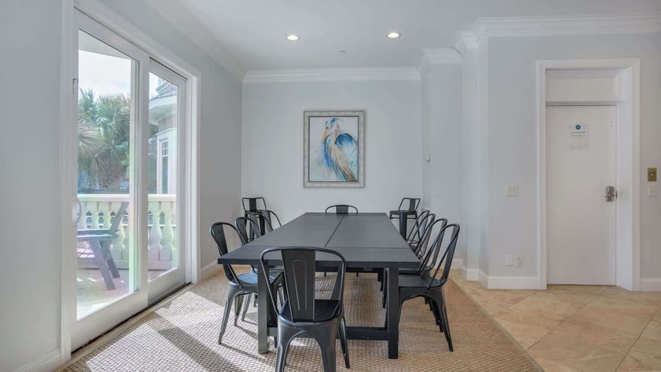Step into this spacious dining room, where a beautifully crafted table accommodates 10 people, making it perfect for family dinners or entertaining friends. The bright, airy ambiance enhances the dining experience, creating a warm setting