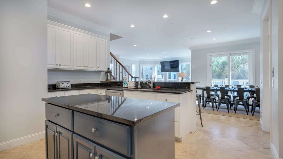 Step into this fully equipped kitchen, designed for both cooking and entertaining. Featuring modern appliances and ample counter space, it’s perfect for preparing meals while enjoying the company of friends and family at the convenient bar seating.