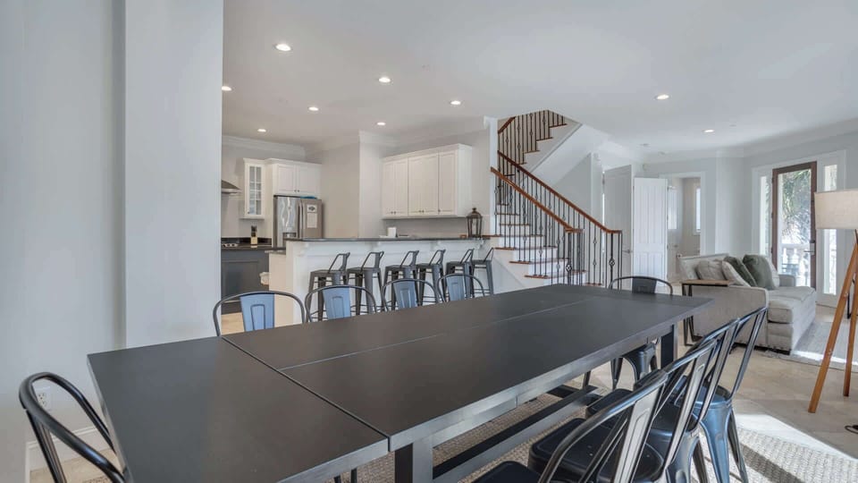 This elegant dining room is designed for gatherings, featuring a large table that comfortably seats 10 guests. With ample space to move around and beautifully decorated surroundings, it creates an inviting atmosphere for family meals and celebrations