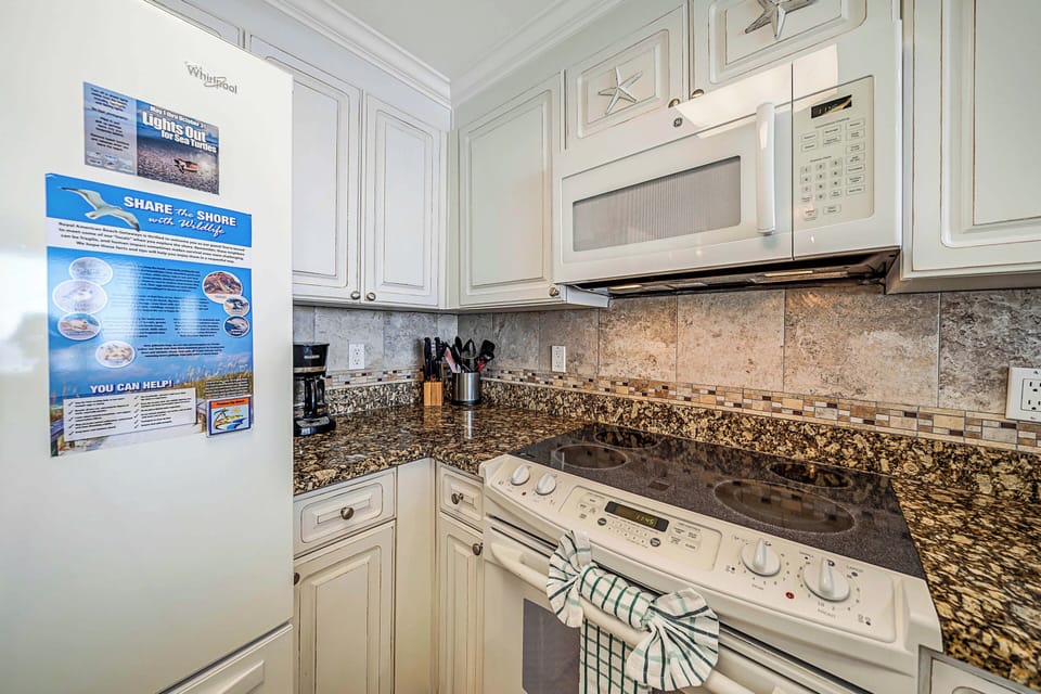 The fully equipped kitchen features granite countertops and has everything you need to prepare meals for family & friends.
