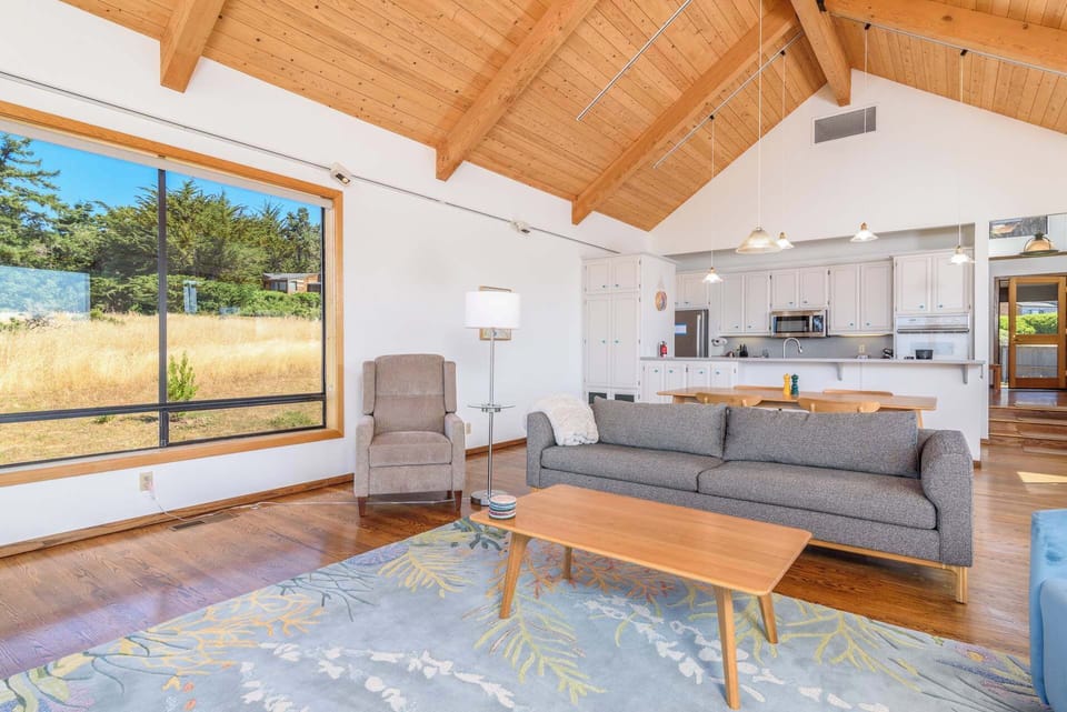 Bright open living space with ample seating, amazing view, fireplace, and patio access