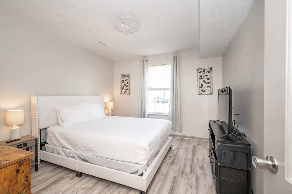 The 1st of 2 bedrooms in Apartment 2 boasts a plush queen bed & Smart TV
