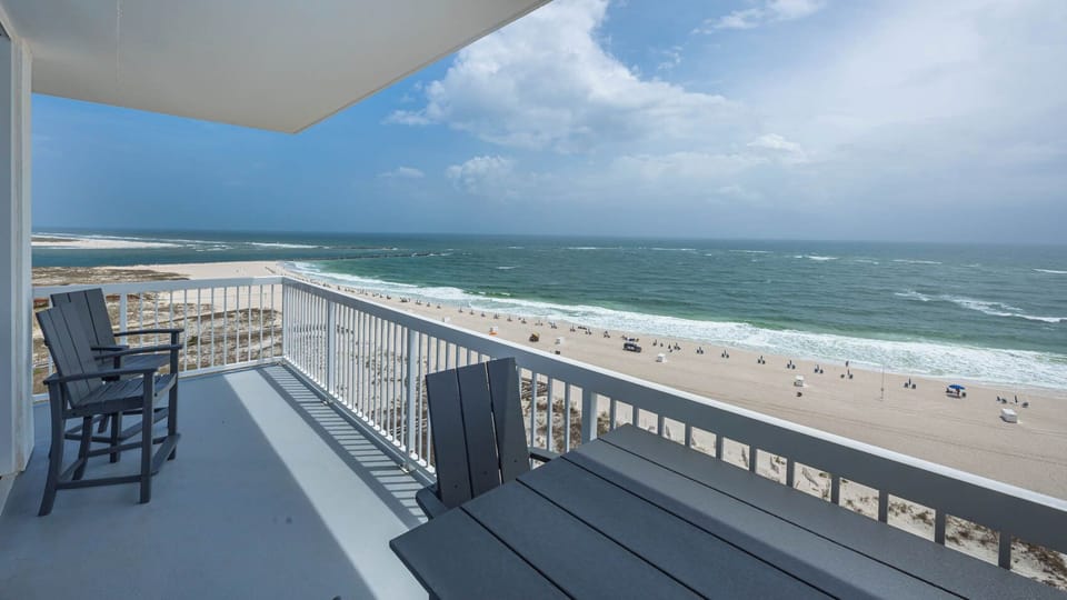 Enjoy a stunning beachfront view of the beach and jetties from the balcony, complete with comfortable seating for relaxation