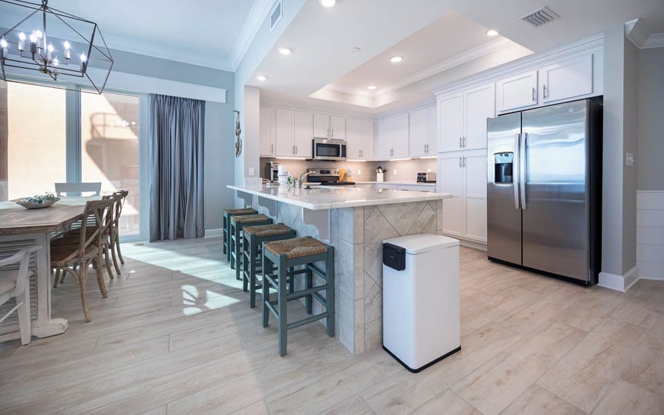 Sip your morning coffee at the breakfast bar and get ready for a beach day in this stylish space