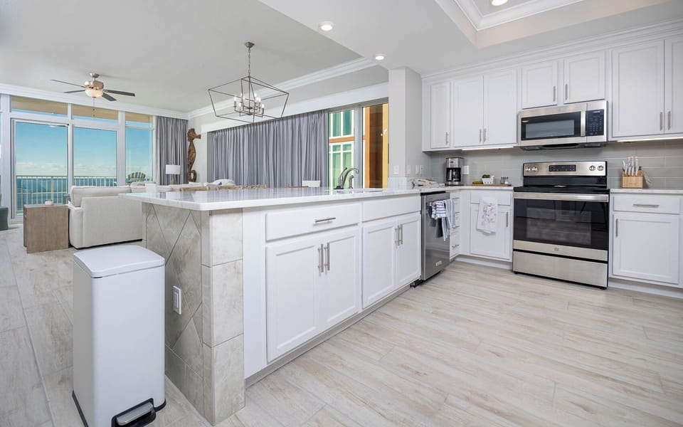 Prepare meals in this kitchen with elegant cabinetry, stainless appliances, and spacious countertops