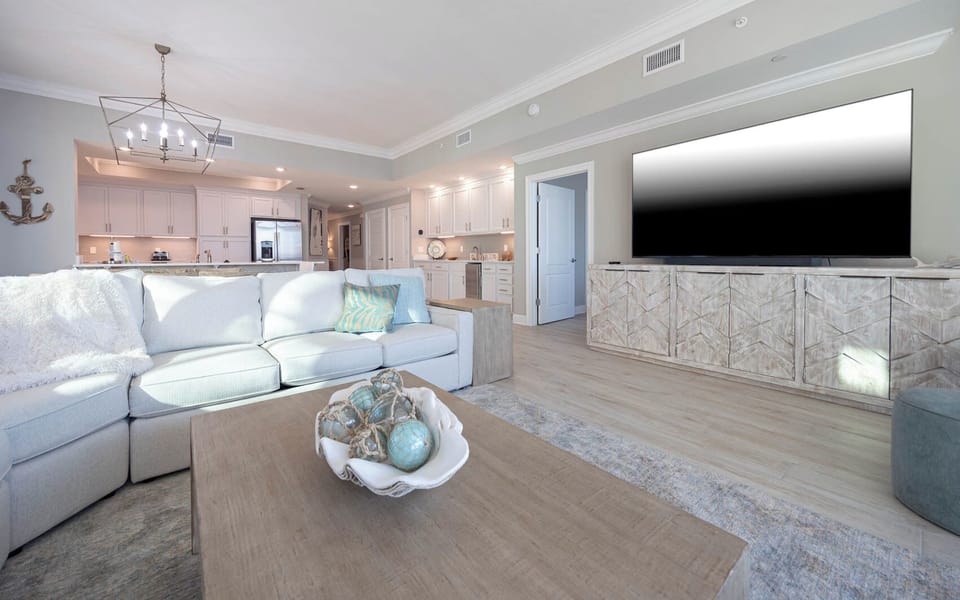 Sink into the plush sofa and stream favorite shows on the large TV as warm gulf light fills the room